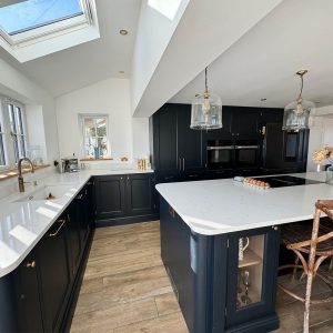 Navy kitchen with island, white worktops and roof window β kitchens by Fen Developments